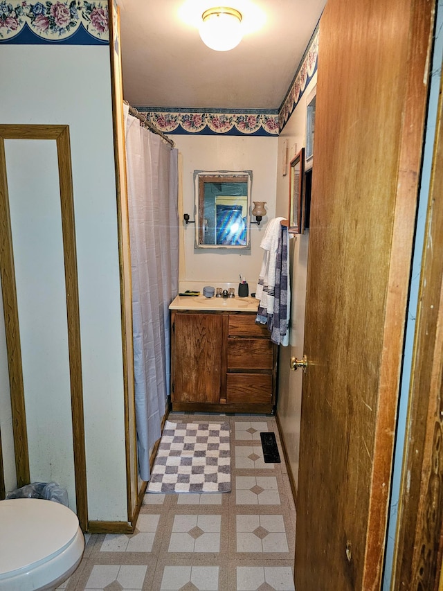 bathroom featuring vanity, toilet, and a shower with shower curtain