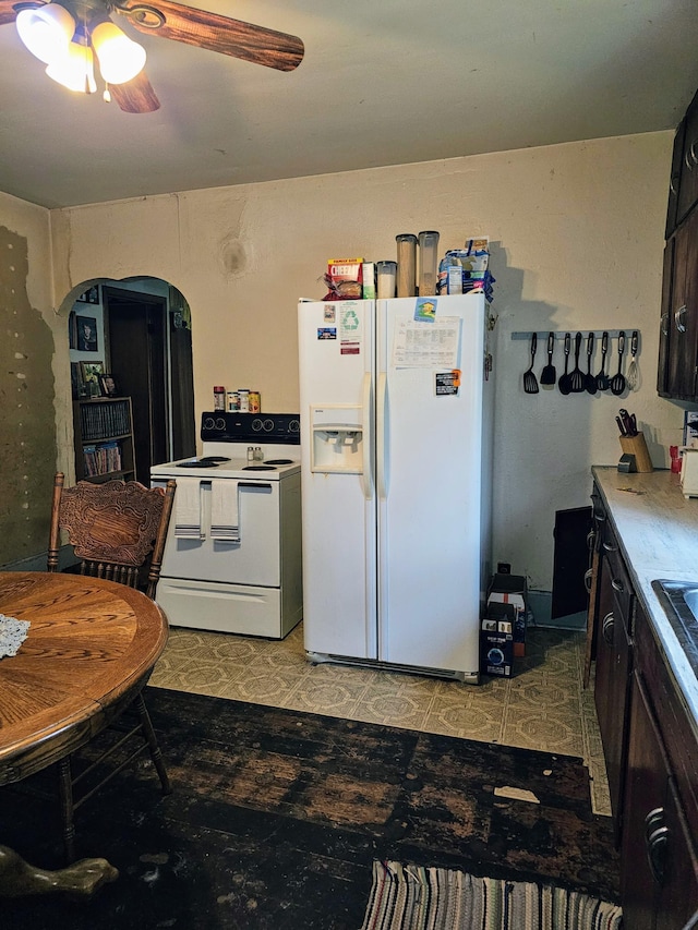 kitchen with white appliances, ceiling fan, and dark brown cabinetry