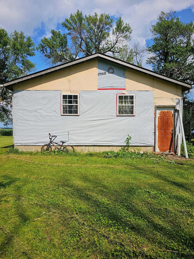 view of property exterior with a yard