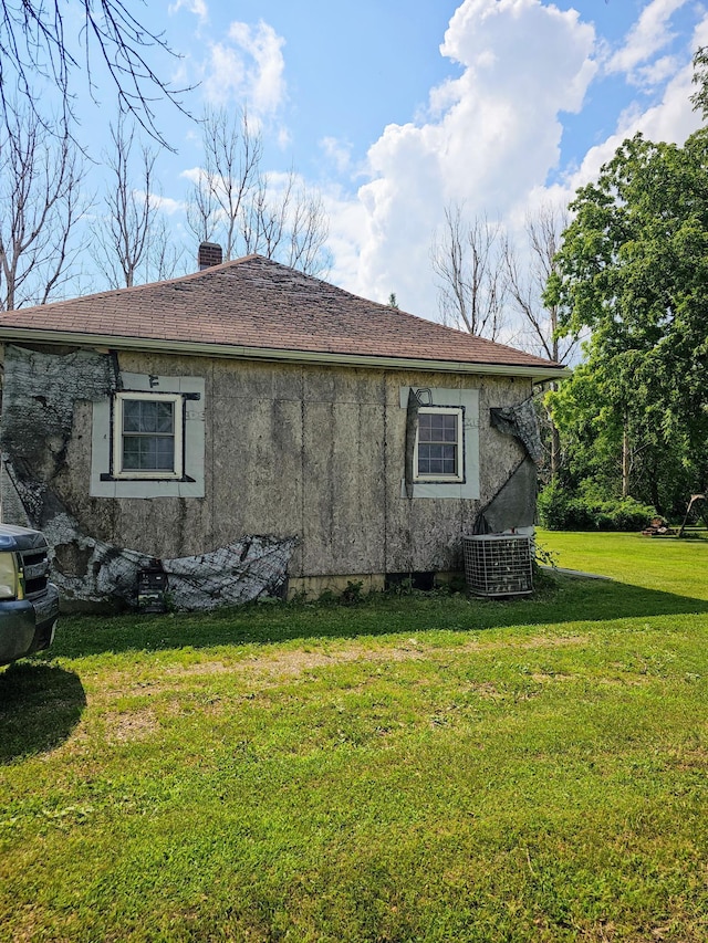 view of side of property with a yard