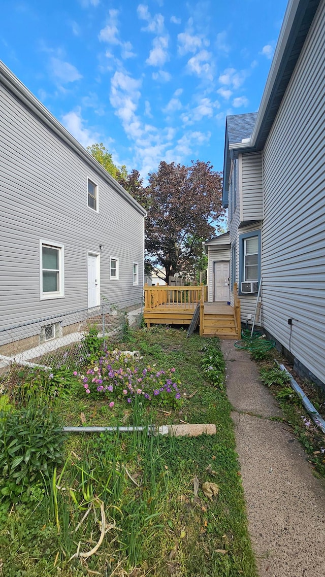 view of yard featuring cooling unit and a wooden deck