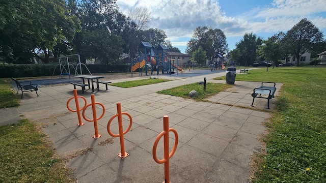 view of home's community with a playground and a lawn