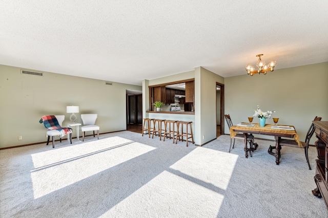 9700 Portland Ave S Unit 225, Bloomington, MN 55420 - carpeted dining area featuring a textured ceiling, a chandelier, and baseboards