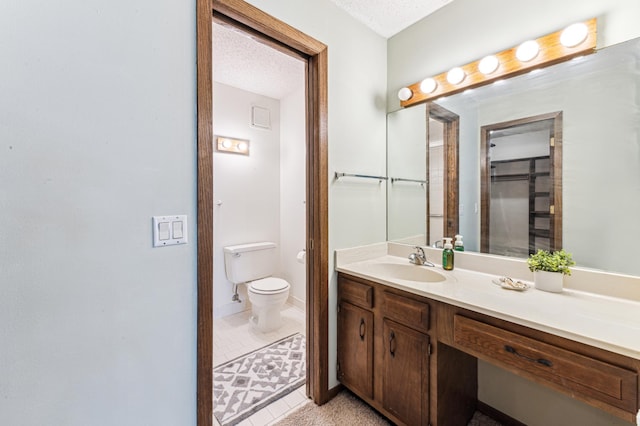 9700 Portland Ave S Unit 225, Bloomington, MN 55420 - bathroom with vanity, toilet, tile patterned floors, and a textured ceiling