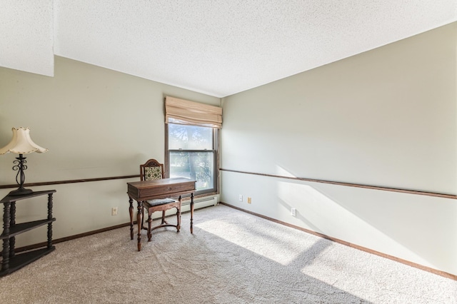 office space featuring a textured ceiling, baseboard heating, and light colored carpet