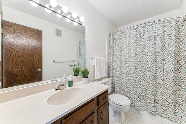 bathroom with vanity, tile patterned floors, curtained shower, toilet, and a textured ceiling