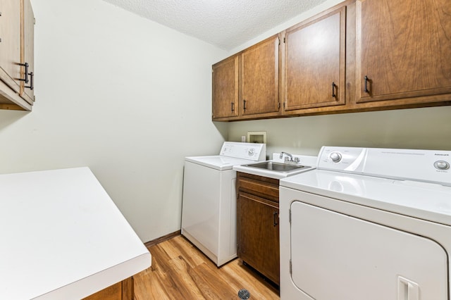 9700 Portland Ave S Unit 225, Bloomington, MN 55420 - washroom with cabinet space, washing machine and dryer, light wood finished floors, a textured ceiling, and baseboards
