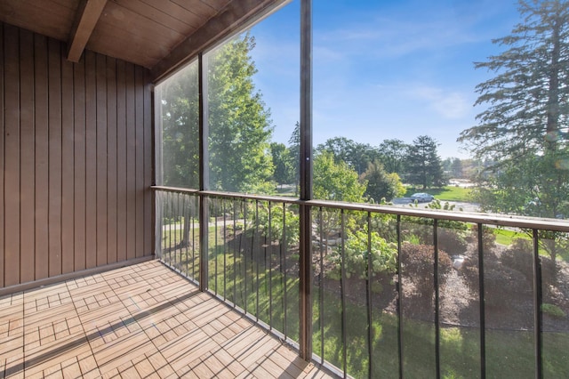 unfurnished sunroom with beamed ceiling and wooden ceiling