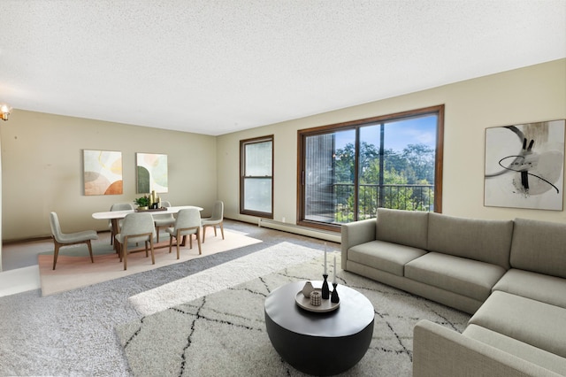 9700 Portland Ave S Unit 225, Bloomington, MN 55420 - carpeted living room featuring a baseboard radiator, a textured ceiling, and a chandelier