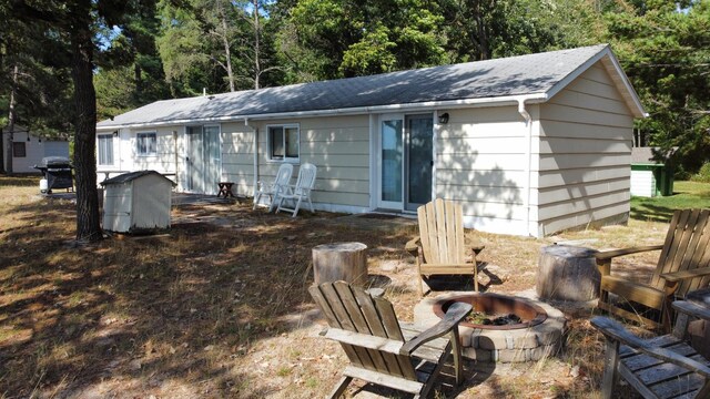 rear view of house with a fire pit