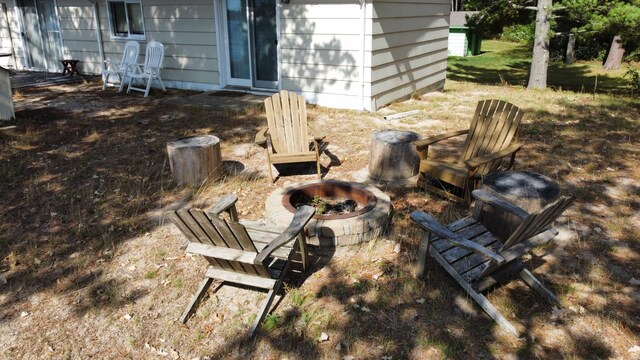 exterior details featuring an outdoor fire pit