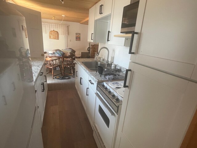 kitchen featuring white cabinets, sink, white appliances, wooden ceiling, and dark hardwood / wood-style flooring