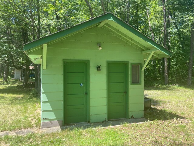 view of outdoor structure with a lawn