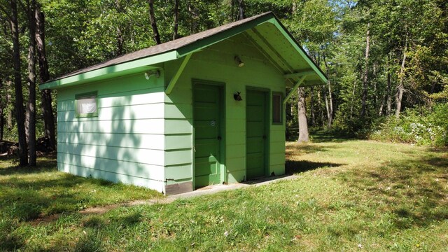 view of outdoor structure featuring a lawn