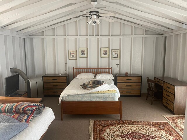 carpeted bedroom featuring ceiling fan and lofted ceiling with beams