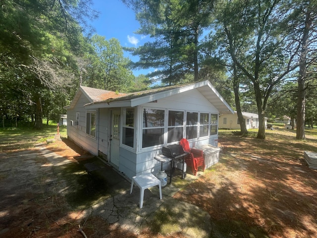 view of side of property featuring a sunroom