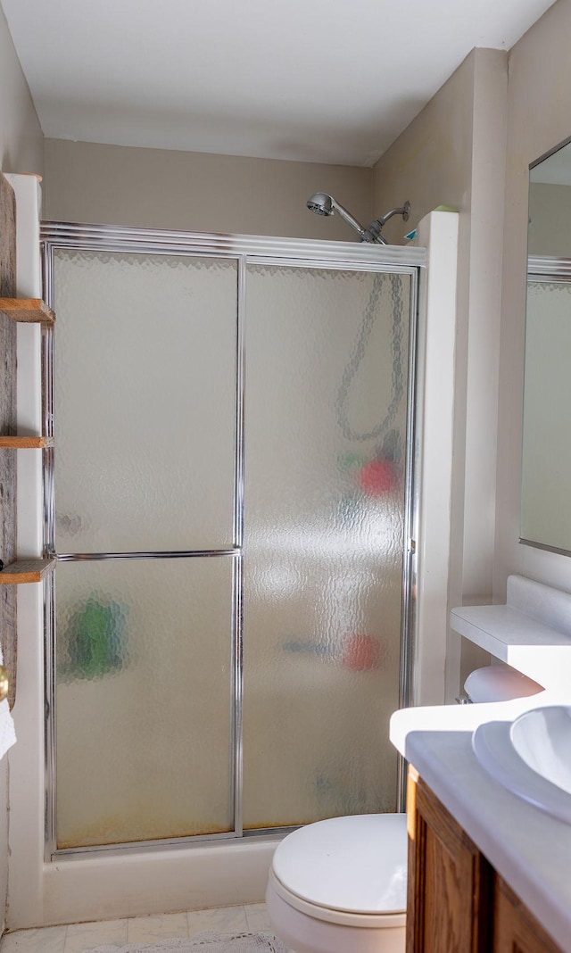 50165 Sailer Rd, Frazee, MN 56544 - bathroom featuring vanity, toilet, tile patterned floors, and a shower with shower door