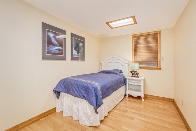 bedroom with hardwood / wood-style floors