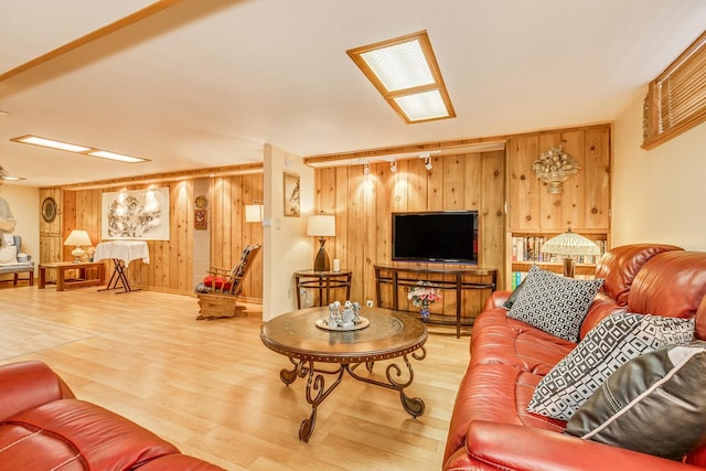 living room with hardwood / wood-style flooring and wooden walls