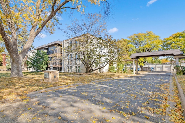 6301 York Ave S Unit 102, Edina, MN 55435 - view of home's exterior featuring aphalt driveway and a carport