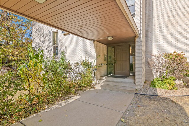 6301 York Ave S Unit 102, Edina, MN 55435 - property entrance featuring a carport and brick siding