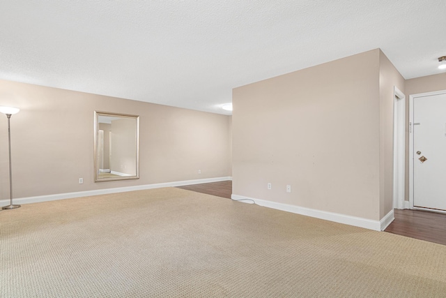 empty room with hardwood / wood-style flooring and a textured ceiling