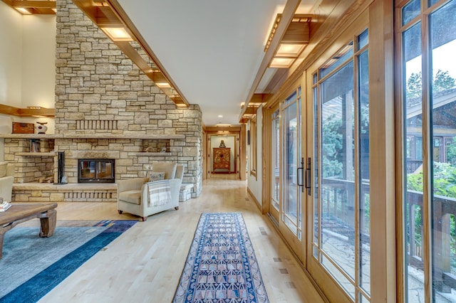 unfurnished sunroom featuring french doors and a fireplace