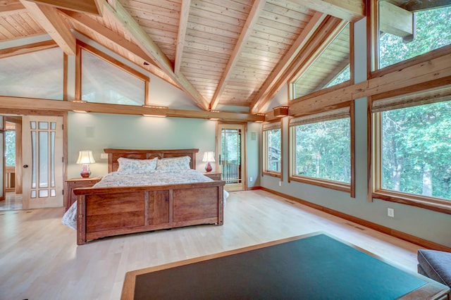 unfurnished bedroom featuring multiple windows, high vaulted ceiling, beamed ceiling, and light hardwood / wood-style flooring