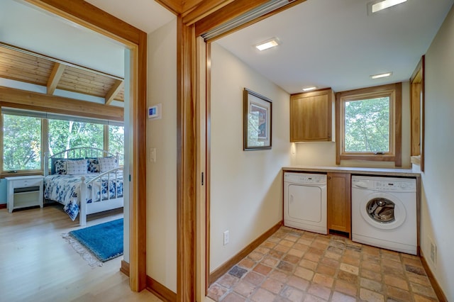 washroom featuring cabinets and washer and dryer