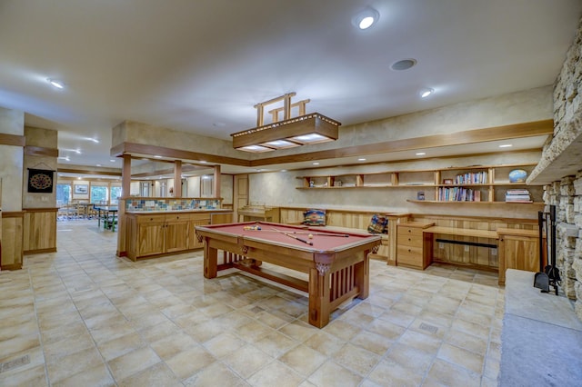 game room featuring billiards, built in desk, and a fireplace