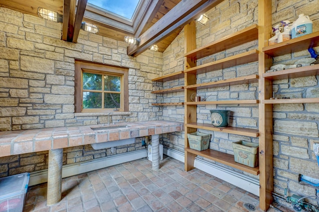 interior space with vaulted ceiling with skylight