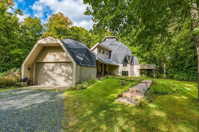 view of front of property with a front yard and a garage