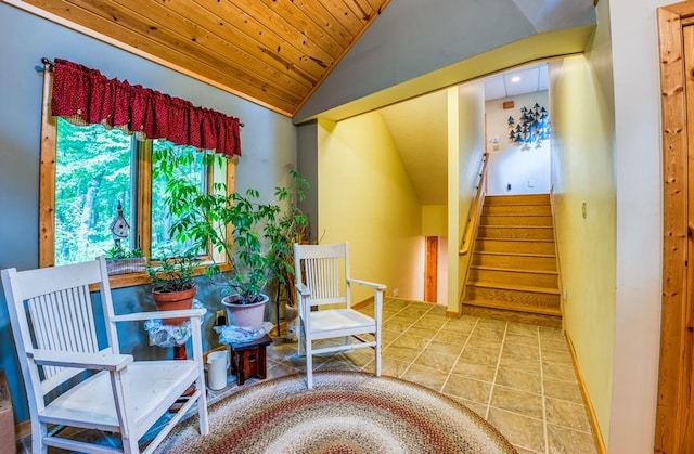 living area featuring lofted ceiling, wood ceiling, and tile patterned floors