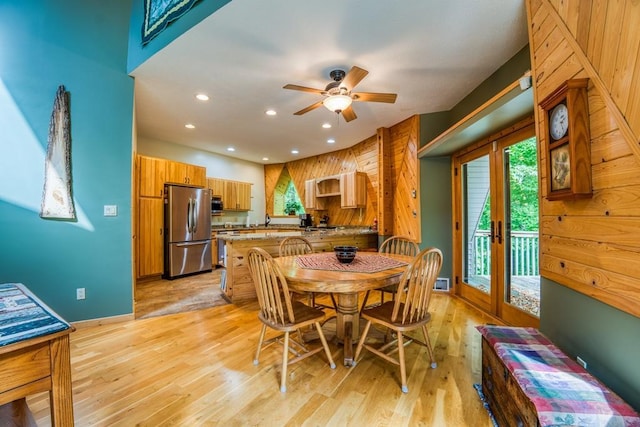 dining space with light wood-type flooring and ceiling fan