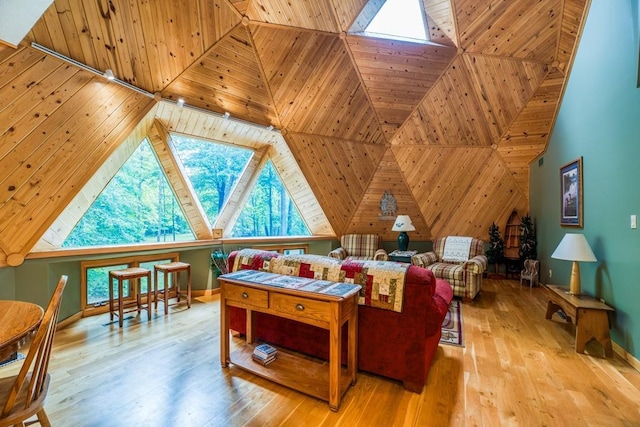 living room featuring a skylight and light hardwood / wood-style flooring