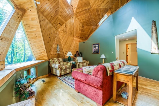 interior space featuring light wood-type flooring, plenty of natural light, wooden ceiling, and wooden walls