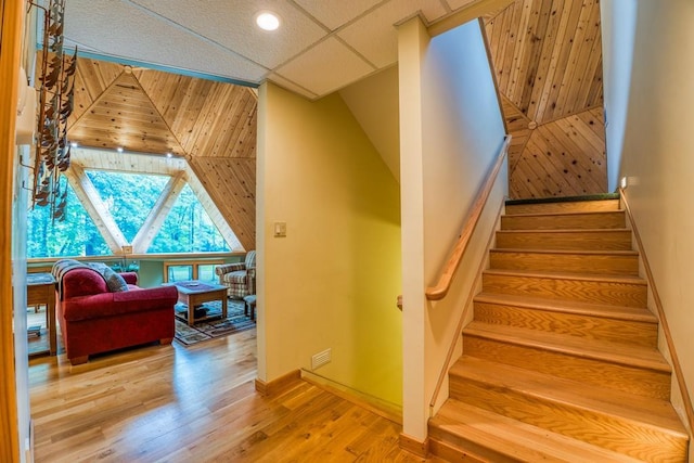 staircase featuring hardwood / wood-style flooring and a paneled ceiling