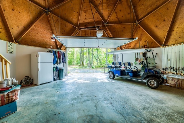 garage with a garage door opener and white refrigerator