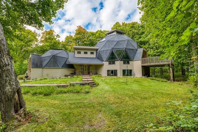 back of house with a yard and a wooden deck