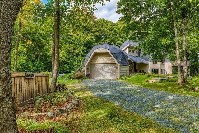 56008 County Road 4, Spring Lake, MN 56680 - view of front facade with a gambrel roof, a garage, driveway, and a shingled roof
