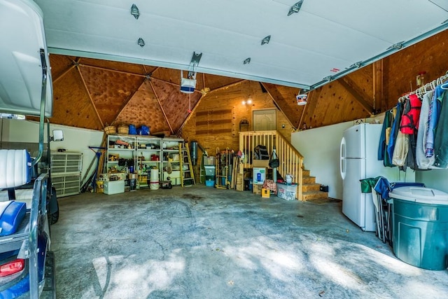 garage featuring a garage door opener and white fridge