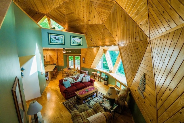 56008 County Road 4, Spring Lake, MN 56680 - living room with wood finished floors, high vaulted ceiling, wooden walls, wood ceiling, and a ceiling fan