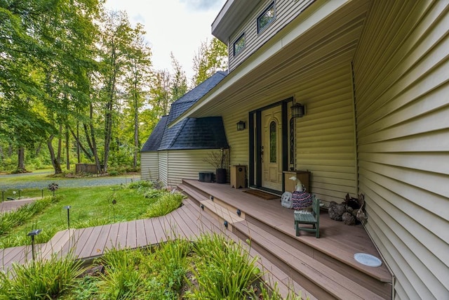 wooden deck featuring a lawn