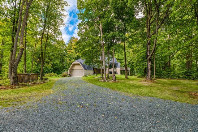 56008 County Road 4, Spring Lake, MN 56680 - view of front facade with an outbuilding, a front yard, a detached garage, and a forest view