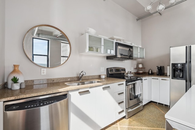 kitchen featuring stainless steel appliances, sink, and white cabinetry