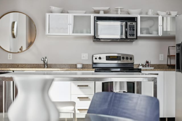 kitchen with appliances with stainless steel finishes and white cabinetry