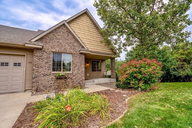 view of front of property featuring a garage and a front lawn