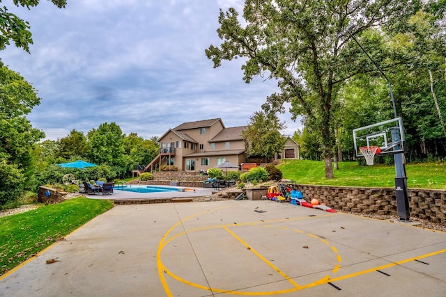 exterior space with a lawn and a swimming pool