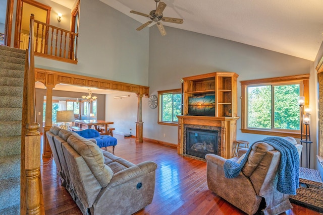 living room featuring ceiling fan with notable chandelier, high vaulted ceiling, hardwood / wood-style flooring, and a healthy amount of sunlight