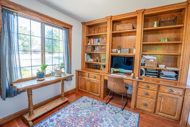 office area featuring light wood-type flooring and built in desk